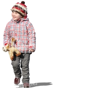 smiling girl walking with a toy in her hand