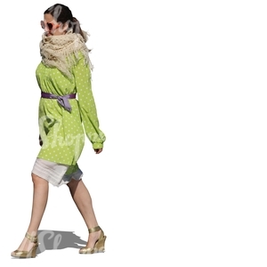 cut out woman in a green dress walking