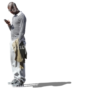 cut out black man standing and looking at his phone