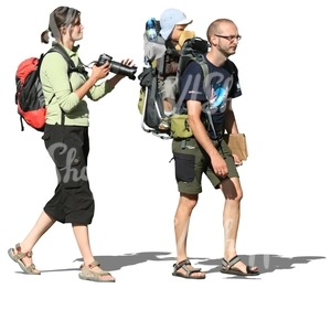 travelling family walking with backpacks