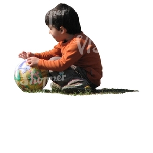 boy with a ball squatting on the grass
