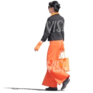 woman in a black and orange outfit walking