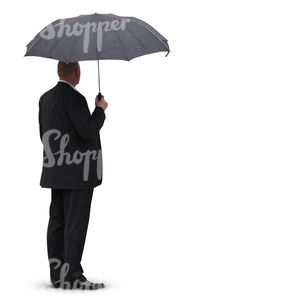 man in a black suit standing under an umbrella