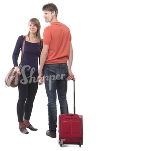 travelling couple standing with a suitcase