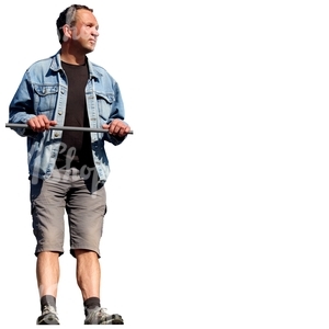 man in a denim jacket standing against the railing
