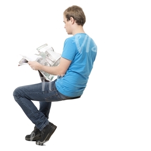 young man sitting and reading a newspaper