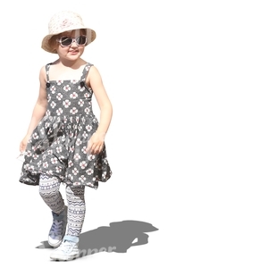 young girl in a summer dress walking and smiling