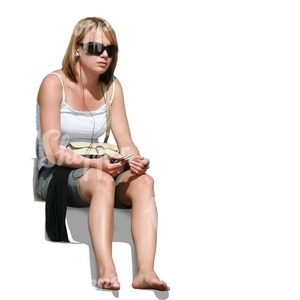 barefoot young woman with headphones sitting and listening to music