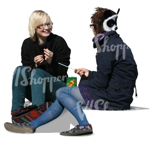 two girls sitting and talking on the sidewalk