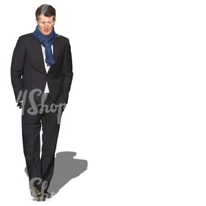man with a blue scarf walking hands in his pocket