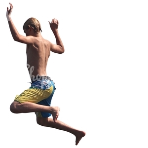 young boy in swimming shorts jumping into the water