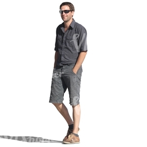 man in a dark blue outfit walking hands in his pocket
