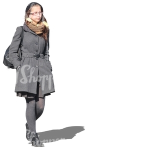 young woman in grey outfit walking