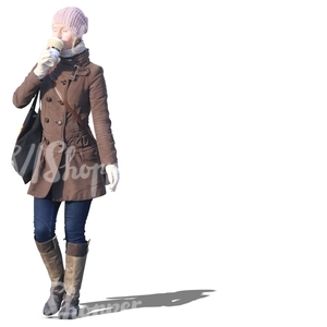 woman walking and drinking coffee