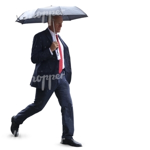 businessman with an umbrella walking in the rain