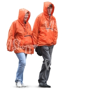 two people in orange raincoats walking hand in hand