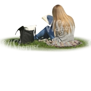 woman sitting on the grass and reading