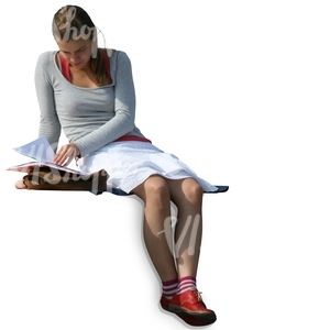 A girl sitting and reading a book