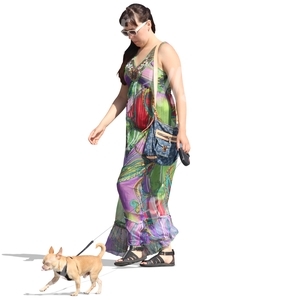 woman in a dress walking a small dog