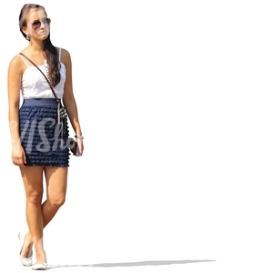dark haired woman in a mini skirt standing