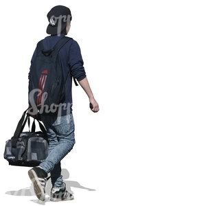 young boy walking and carrying a sports bag
