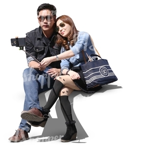 asian couple sitting and taking a selfie