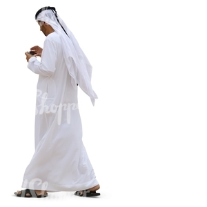 arab man walking and looking at his phone