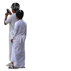 two muslim boys standing and taking a picture