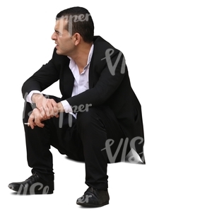 businessman sitting on the sidewalk
