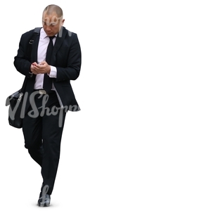 asian businessman walking while looking at his phone