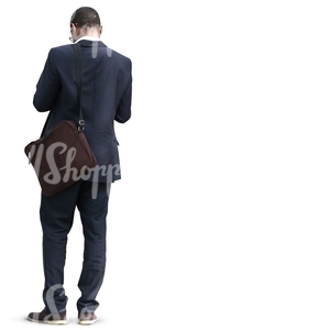 african businessman standing and looking at his phone