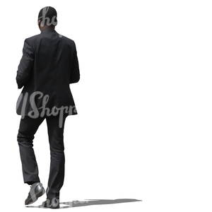 african businessman in a black suit walking