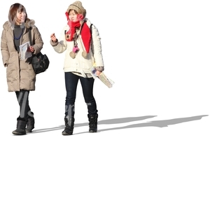 two asian women walking with maps in their hands