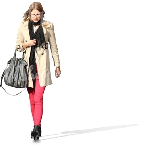 young woman in a beige spring coat walking