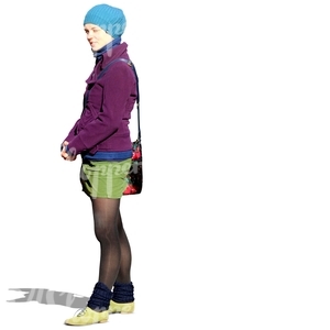 woman in a colorful autumn outfit standing on the street