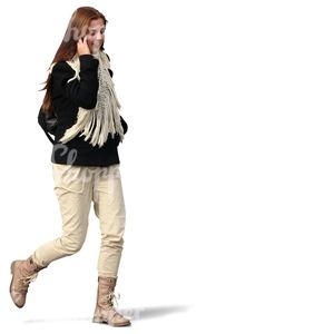 smiling woman walking and talking on the phone