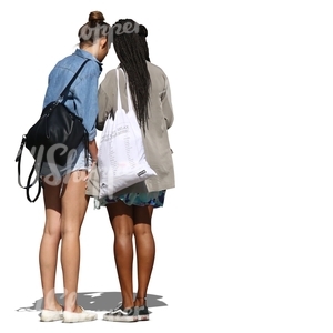 two women standing and looking at smth