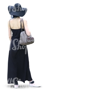 woman with a black hat and long black dress standing