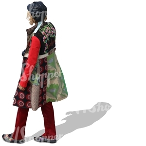 woman with a colorful coat and leather hat walking