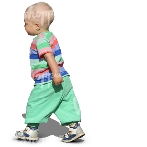 toddler in green trousers walking