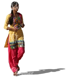 indian woman in a colorful traditional attire walking