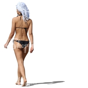 woman wearing a black bikini walking on the beach