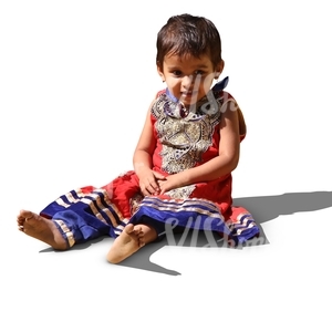 little hindu girl in a fancy dress sitting no the ground