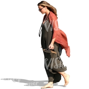 woman walking barefoot on the beach