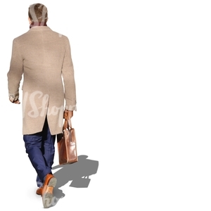 man in a beige coat walking with a suitcase