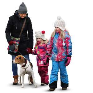 family with two children and a dog walking in wintertime