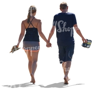 couple walking hand in hand on the beach