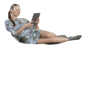 woman lying on the couch and looking at her ipad