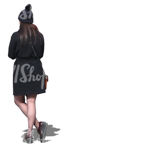 woman wearing a black coat and hat standing