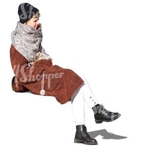 woman wearing a brown coat sitting in sunlight